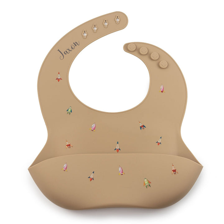 JBØRN Silicone Baby Feeding Bib | Weaning Essentials | Personalisable in Rockets Taupe, sold by JBørn Baby Products Shop, Personalizable by JustBørn